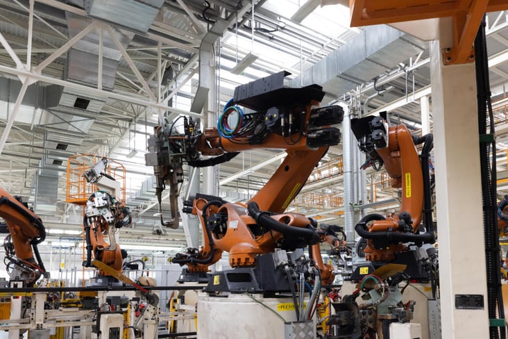 A factory robot assembling a auto part in ev unit